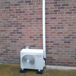 Toshiba outdoor unit on feet with ivory trunking