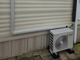 Outdoor unit on feet with trunking