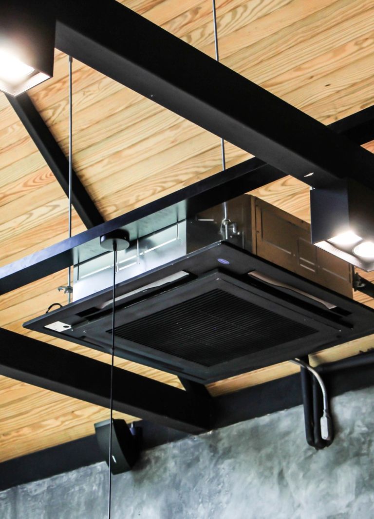 Picture of suspended ceiling cassette with exposed pipwork and drop rods