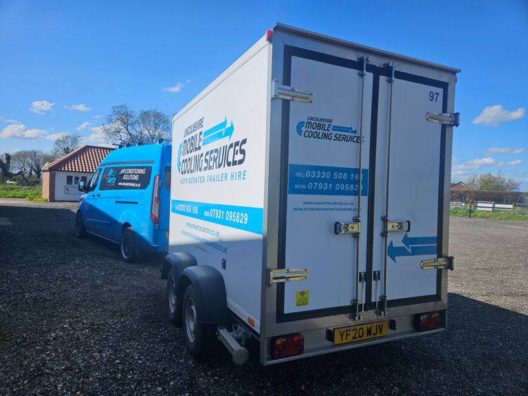 Van towing refrigerated trailer