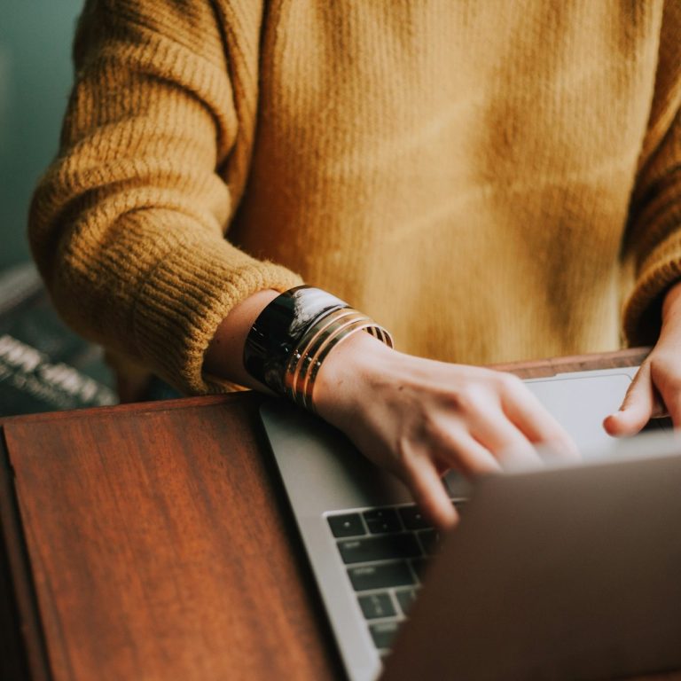 Are you our next new colleague? Cropped picture of someone sat at laptop working